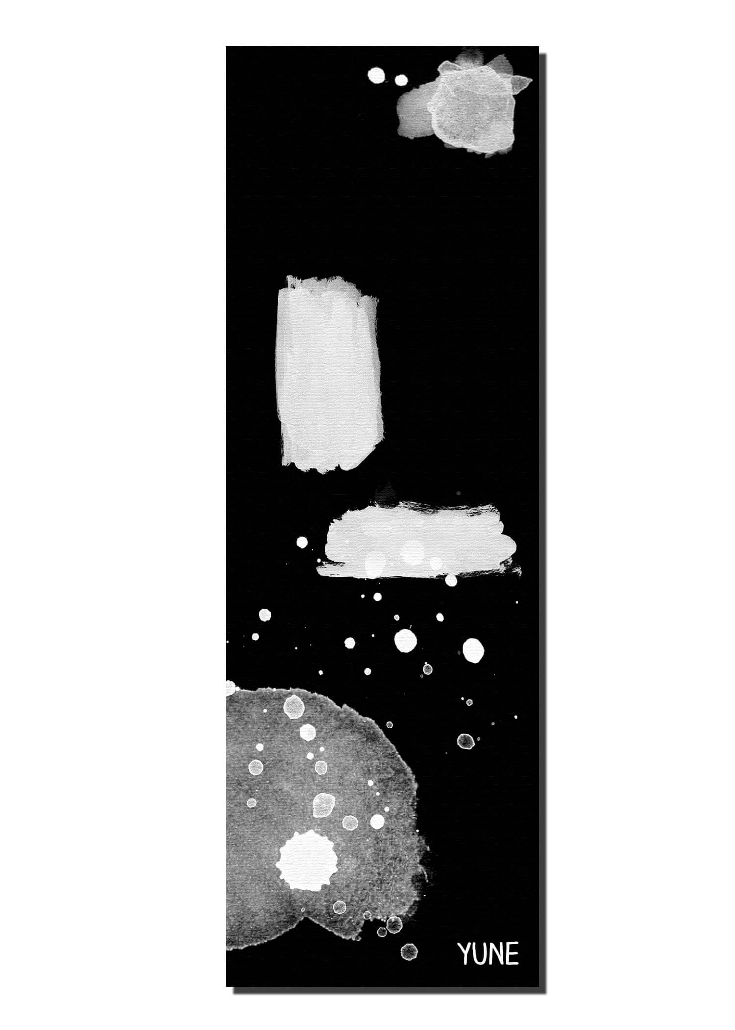 Black yoga mat with abstract white paint splashes and Yune branding, perfect for eco-friendly practice.