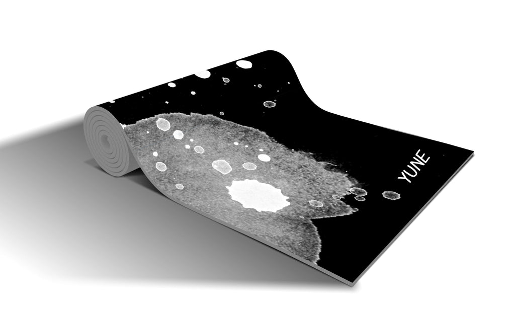 Eco-friendly black Yune yoga mat featuring a unique watercolor design, 6mm thick and non-slip surface.