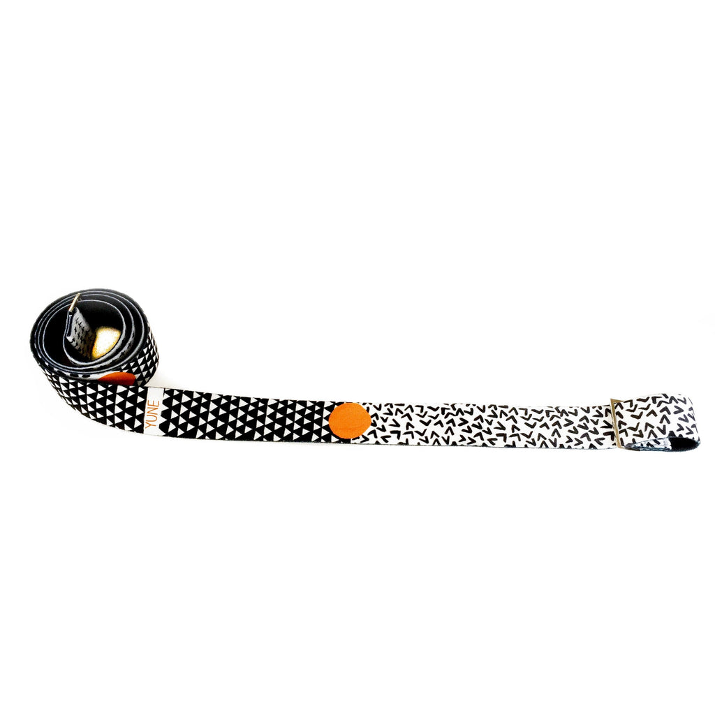Yoga stretching strap with metal buckles, black and white pattern, perfect for stretching and carrying yoga mats.