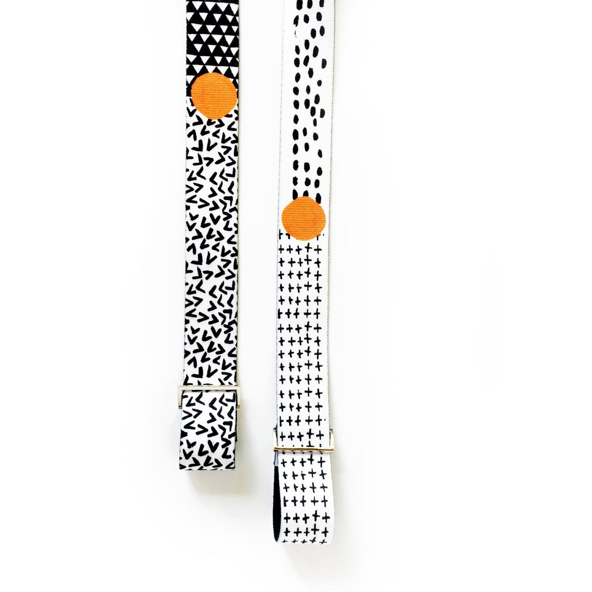 Yoga stretching strap with metal buckles in black and white patterns, perfect for stretching and carrying mats.